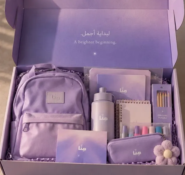 An open MINNA First Day box with a lilac school bag, bottle, notebooks and stationery